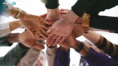 Group of people putting their hands together