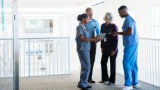 Healthcare professionals talk in hallway