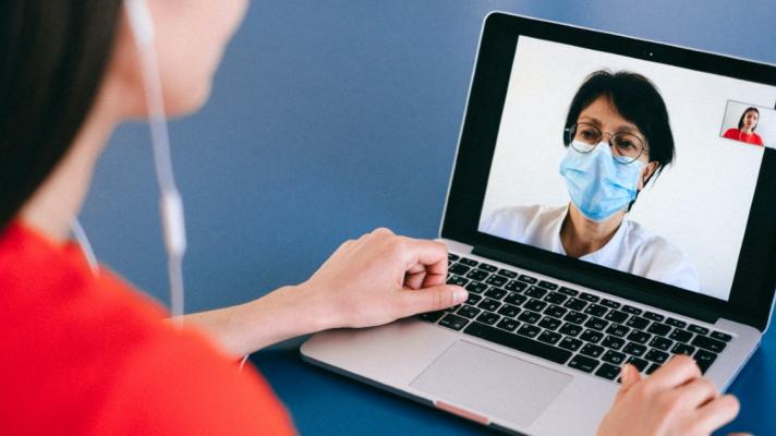 Patient speaking with doctor on laptop via telemedicine