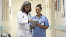 doctor and nurse discuss EHR issues in clinical setting
