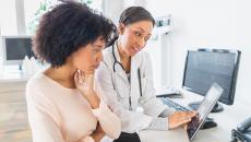 Doctor helping consumer with medical record.