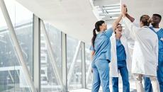 Group of healthcare workers sharing a high-five